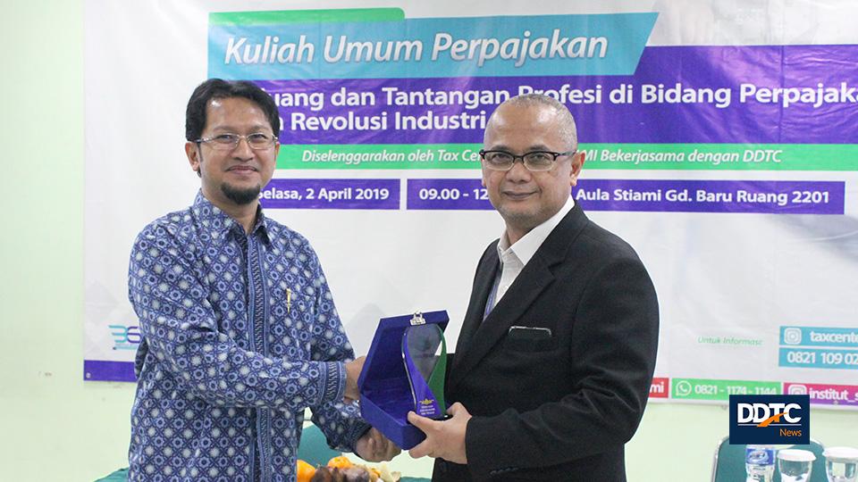 Pemberian plakat dari Institut STIAMI kepada Managing Partner DDTC Darussalam. 