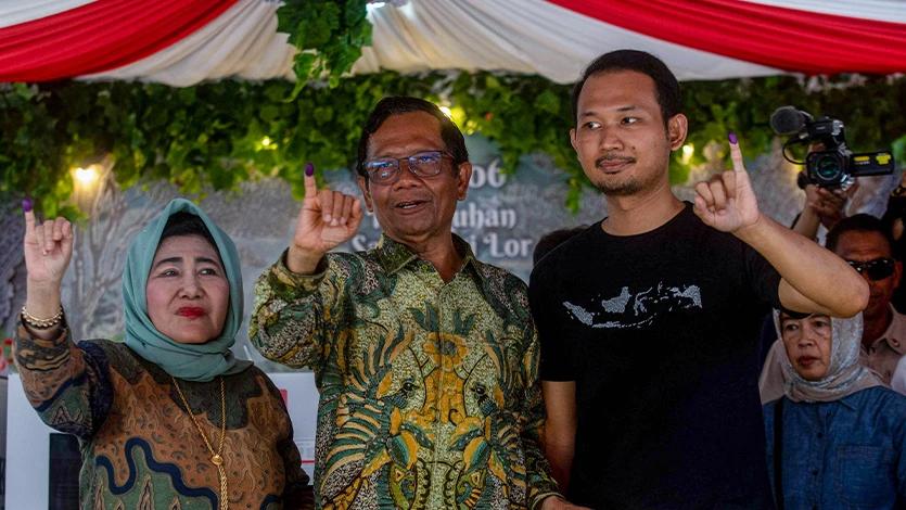 Cawapres nomor urut 3 Mahfud MD (tengah) bersama istri Zaizatun Nihayati (kiri) dan putranya Royhan Akbar (kanan) menunjukkan jarinya yang telah tercelup tinta usai memberikan hak suara pada Pemilu 2024 di TPS 106 Sambilegi Lor, Maguwoharjo, Depok, Sleman, D.I Yogyakarta, Rabu (14/2/2024). ANTARA FOTO/Andreas Fitri Atmoko/agr/tom.